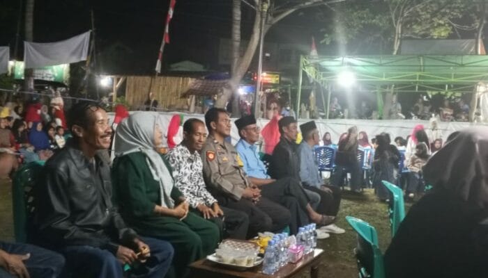 Bhabinkamtibmas Bunga Eja Amankan Perayaan HUT Desa ke-15, Warga Diimbau Kunci Ganda Kendaraan